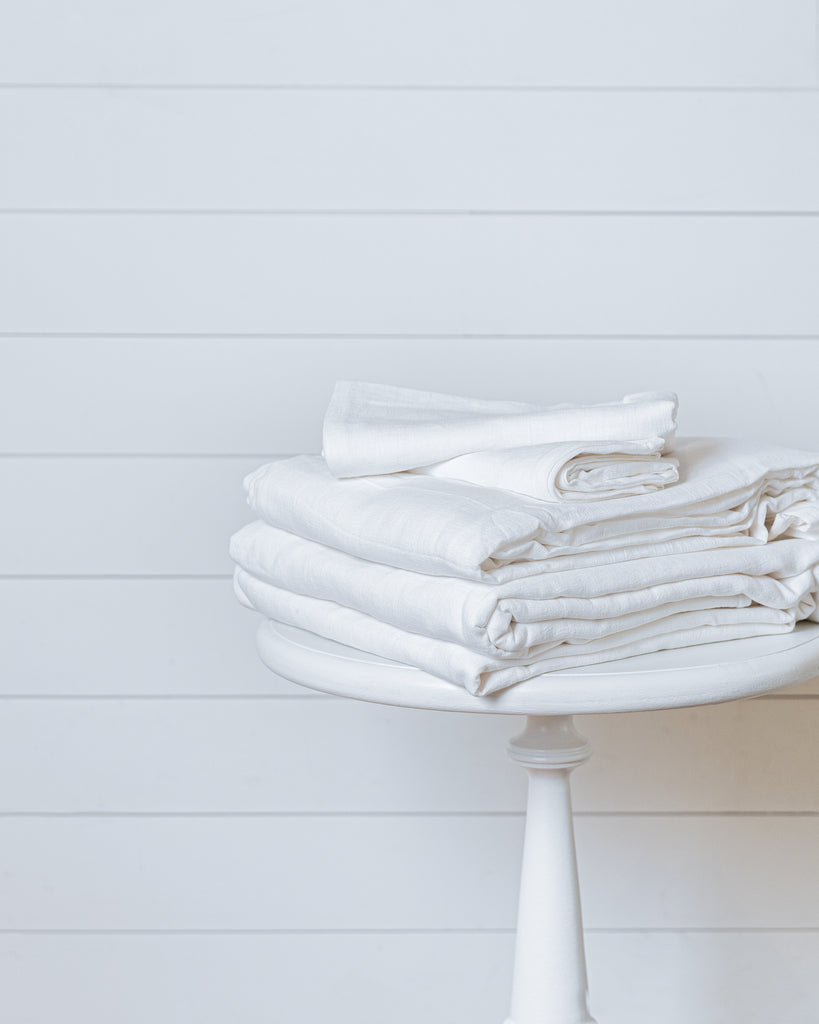 White linen-cotton duvet cover set neatly folded with pillowcases