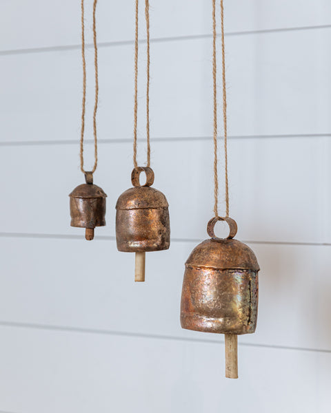 Handcrafted copper vintage bells hanging with natural rope, rustic home decor accent