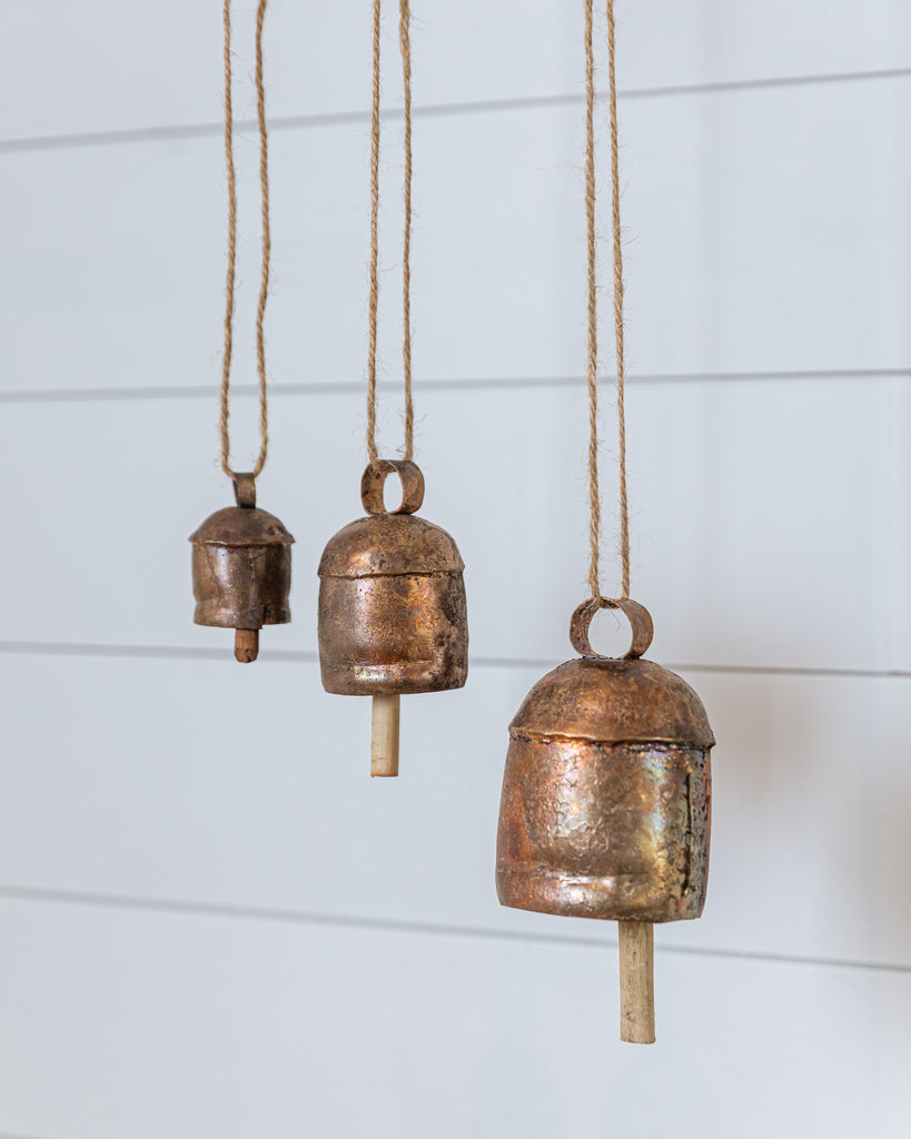 Handcrafted copper vintage bells hanging with natural rope, rustic home decor accent