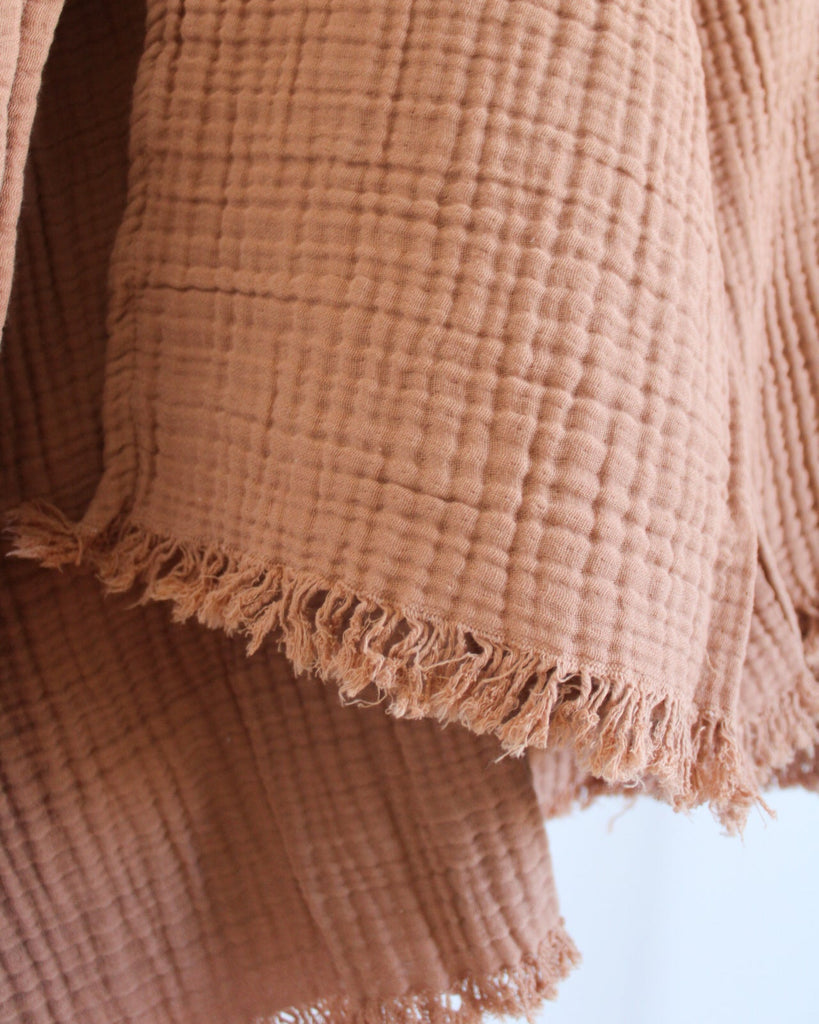 Lightweight cinnamon cannelle muslin throw in Turkish cotton with soft crinkled fabric and tonal fringes