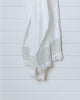 Ivory Turkish cotton waffle towel with sauge stripe displayed hanging on white wall