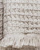 Close-up of beige waffle-knit cotton hand towel showing textured weave