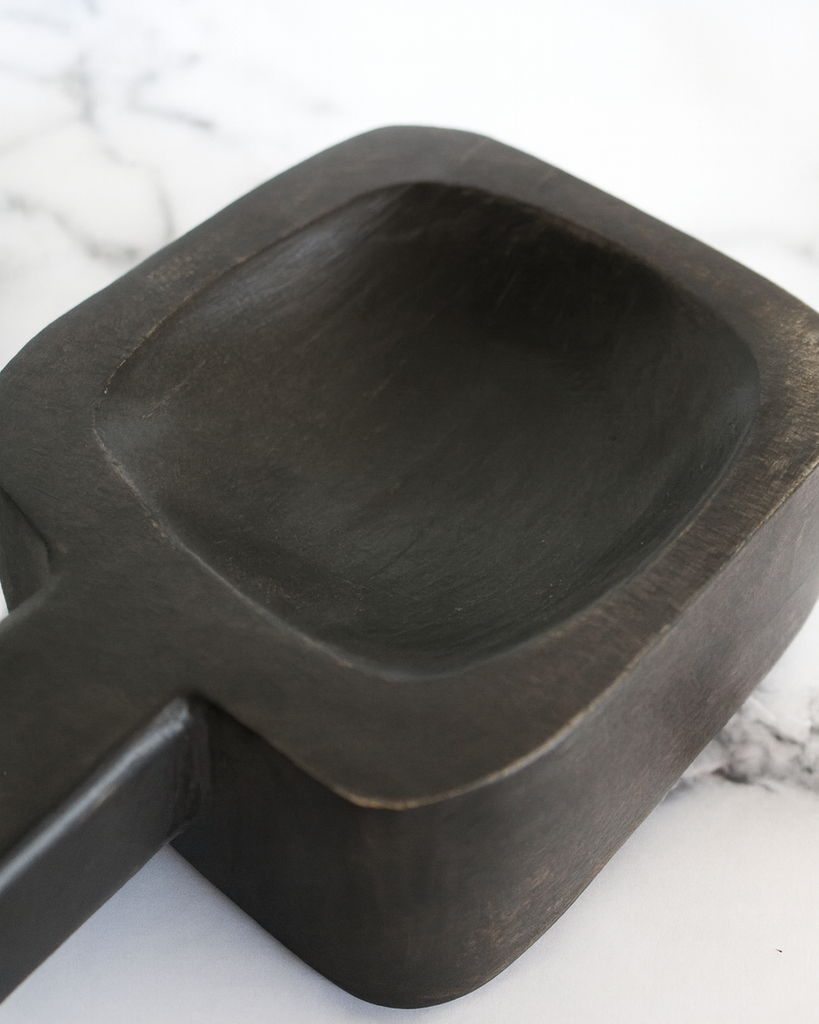 Handcrafted black mango wood serving dish with carved handle, rustic finish