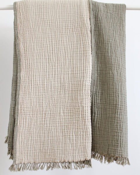 Reversible olive and ecru muslin cotton throw with soft crinkled texture and fringed edges