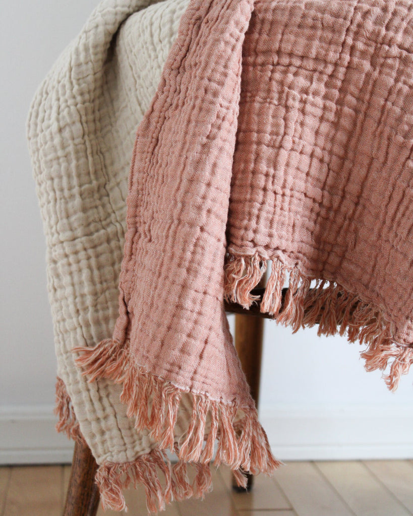Lightweight terracotta and ecru muslin throw blanket in Turkish cotton with soft crinkled fabric and tonal fringes